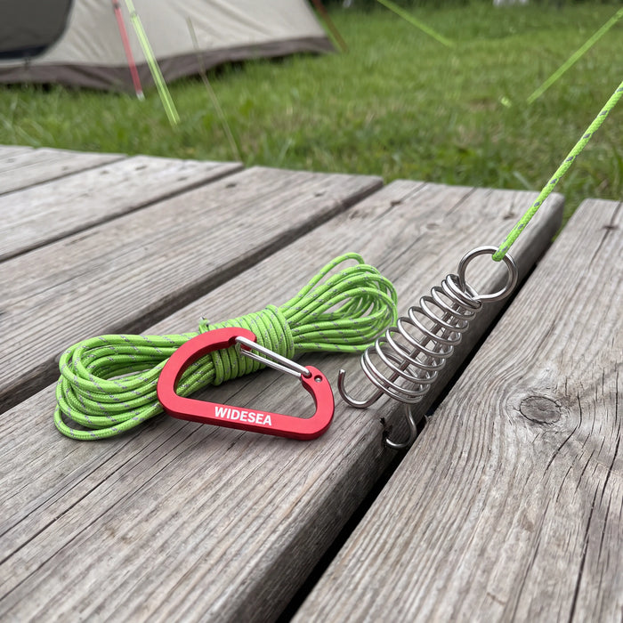 Spiral deck pegs, rope buckles and guy line laid out on decking